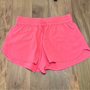 Aritzia TNA Alayli running shorts in dayglo pink